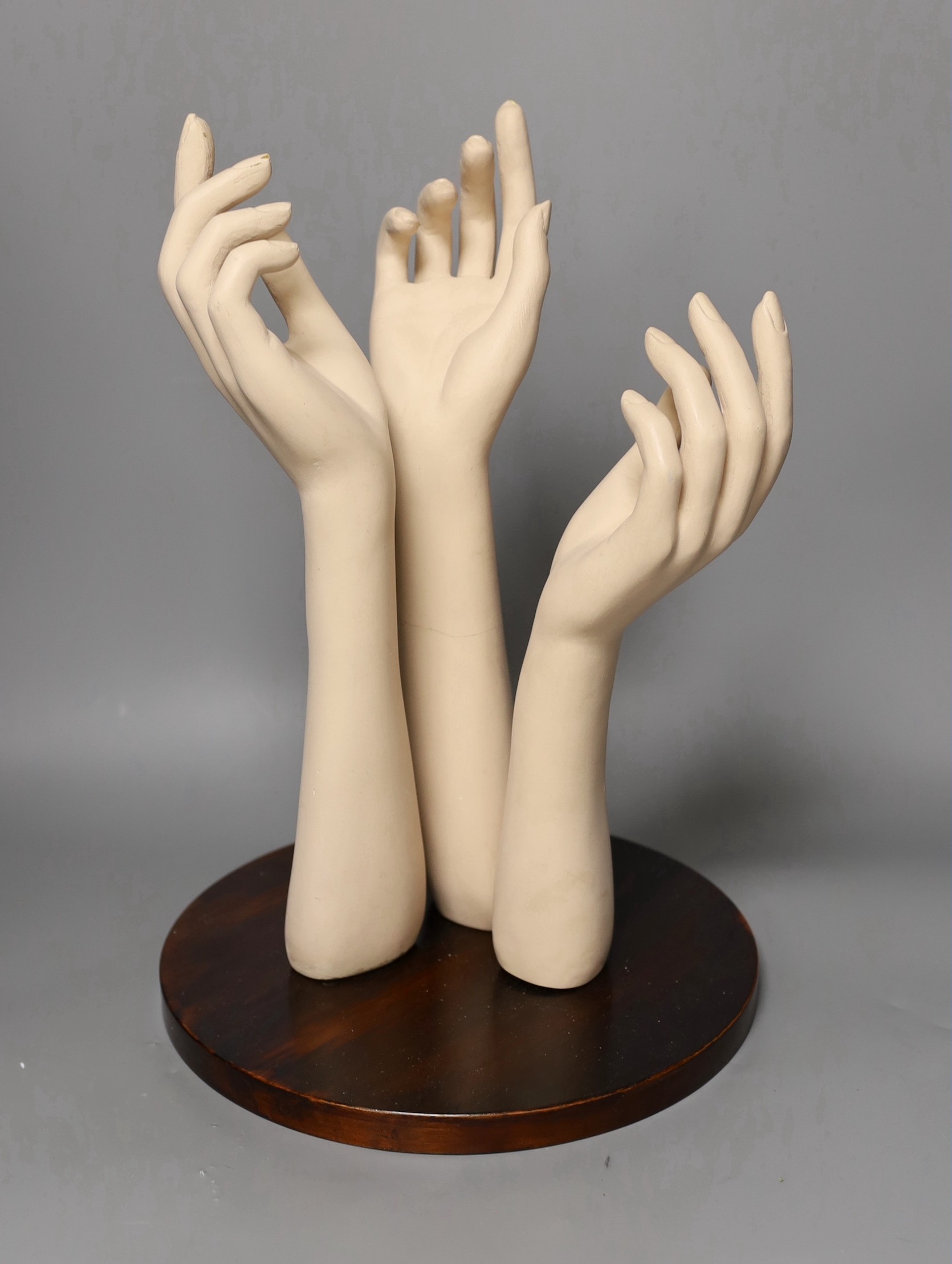 A group of three composite fore-arms on stand, 40 cms high